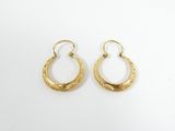 a pair of gold hoop earrings on a white background