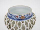 a white vase with a blue and white design on it