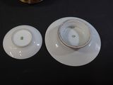 two cups and saucers sitting on a table