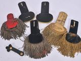 several different types of brooms and hats on a white surface