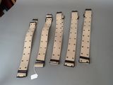 four pieces of tan and black watch straps on a table