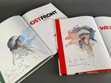 two open books with drawings of a man and a woman on them
