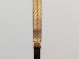 an image of a gold bracelet on a white surface