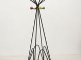 a close up of a metal tree with multi colored balls on it