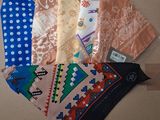 several different types of ties laid out on a cardboard surface