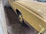 a yellow car that is parked on the side of the road
