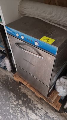 an image of a dishwasher sitting on a pallet in a room