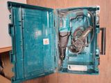 a blue box with a drill and a cord in it