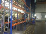 a picture of a large warehouse with a lot of shelves