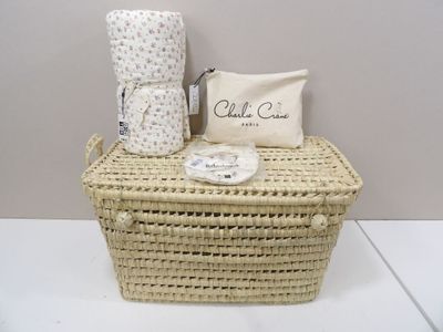 a wicker basket with a blanket and a pillow on it