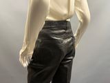 a mannequin wearing a white shirt and black pants