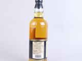 a bottle of whisky sitting on top of a white surface