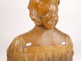 wooden bust of a woman with a hat on a white background