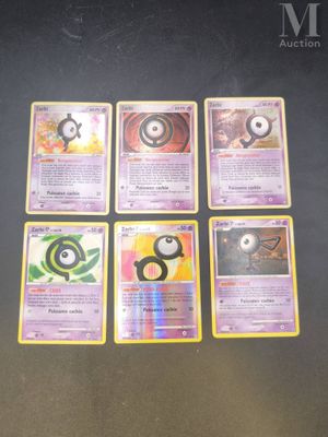 several pokemon cards sitting on top of a table next to each other