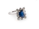 an image of a blue sapphire and diamond ring on a white background