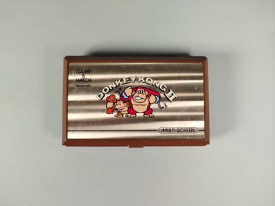 une boîte de Donkey Kong de Nintendo accrochée au mur, à côté d'une manette de Nintendo Wii