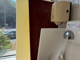 a sink in a public restroom with a window