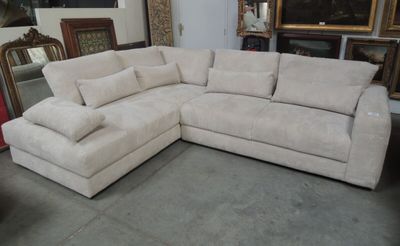 a large sectional couch with pillows on it in a room