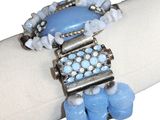 a close up of a bracelet on a napkin