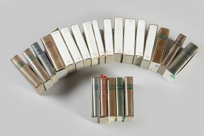 several books are stacked on top of each other on a table