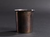 a silver cup that is sitting on a table