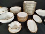 a lot of plates and bowls on the table