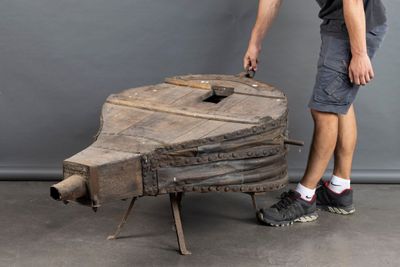 a man that is standing next to a wooden boat