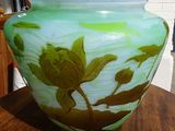 a glass vase sitting on a table with a chain around it