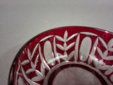 a red bowl with white designs on it on a table