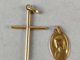 a gold medal and a cross on a white surface