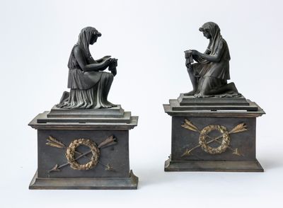 pair of antique bronze figurines of a woman and a man