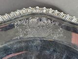 a silver plate with a design on it on a table