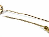 pair of gold tone hair pins with leaves on them