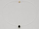 a necklace with a black stone on a white background