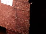 a wooden bench with a sign on it in a dark room