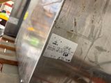 a picture of a stainless steel tank with a sticker on it
