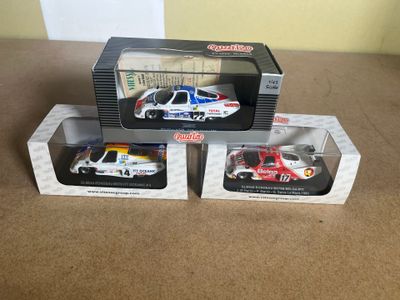 three boxed toy cars are sitting on a table next to each other