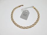 a close up of a gold chain bracelet with a price tag