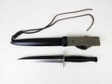 a knife and a knife holder on a white surface