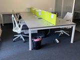 a room with a desk, chairs, and a chair in it