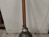 a lamp that is sitting on the ground next to a wall