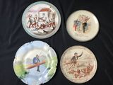 four plates with different designs on them on a black cloth