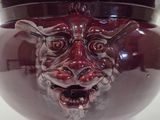 a red bowl with a face on it