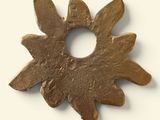 an image of a metal object with a flower in the middle