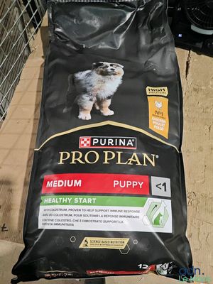 a bag of proplan puppy food on the ground