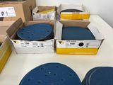 boxes of sanding discs on a table in a room