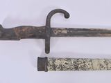 two old swords that are on display on a white surface
