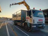 a white truck with a crane on the back of it