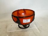 an orange bowl on a stand with a label on it