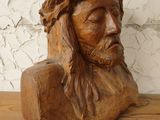 a wooden statue of jesus on a shelf